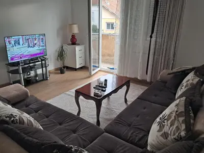 a living room with a couch and a coffee table at Apartman Palma in Belgrade