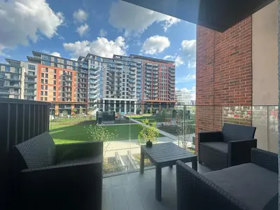 a balcony with chairs and a table and some buildings at Luxury Escape in Belgrade Waterfront in Belgrade