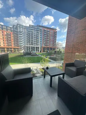 a patio with couches and a table and buildings at Luxury Escape in Belgrade Waterfront in Belgrade