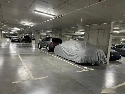 a parking garage with a car under a cover at Luxury Escape in Belgrade Waterfront in Belgrade
