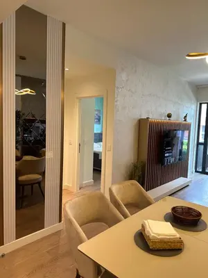 a living room with a table and chairs at Luxury Escape in Belgrade Waterfront in Belgrade
