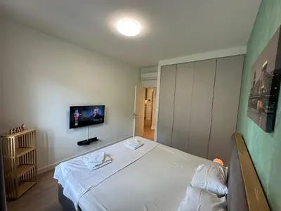 a bedroom with a bed and a flat screen tv at Luxury Escape in Belgrade Waterfront in Belgrade