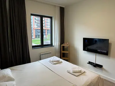 a bedroom with a bed and a tv on a wall at Luxury Escape in Belgrade Waterfront in Belgrade