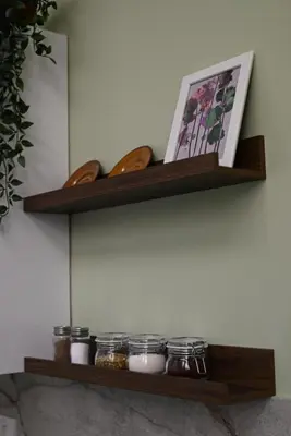 a shelf on a wall with jars and a picture at La Pastorela in Belgrade