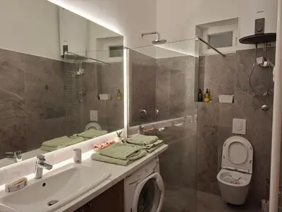 a bathroom with a sink and a toilet and a mirror at La Pastorela in Belgrade