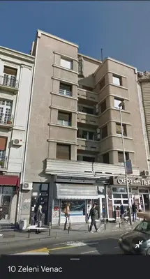 a group of people walking in front of a building at La Pastorela in Belgrade