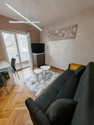 a living room with a couch and a table at Apartman Miladinović in Belgrade