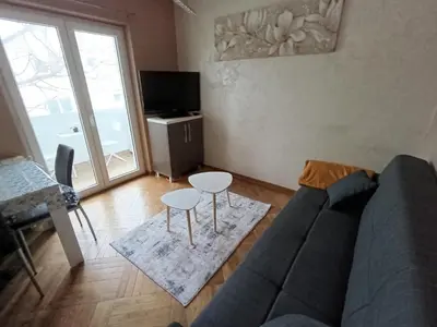 a living room with a couch and a table at Apartman Miladinović in Belgrade