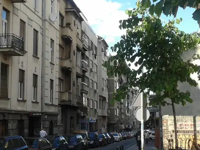 a street with cars parked on the side of the road at Apartment Angie in Belgrade