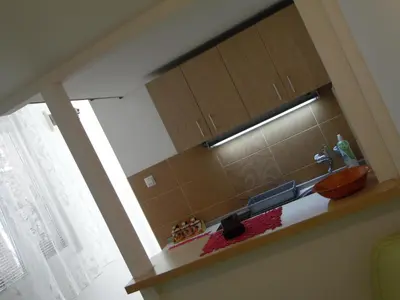 a kitchen with a counter top with a window at Apartment Angie in Belgrade