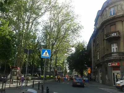 a blue sign on the side of a city street at Apartment Angie in Belgrade