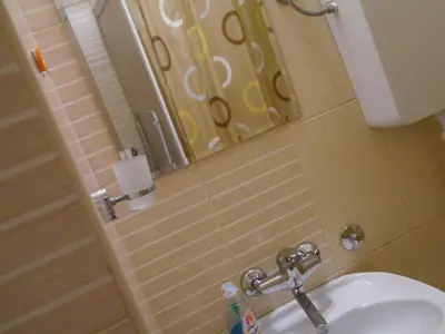 a bathroom with a sink and a mirror at Apartment Angie in Belgrade