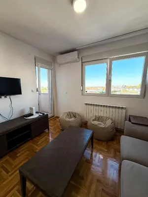 a living room with a couch and a table at Limpio Apartman in Belgrade