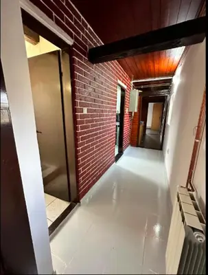 an empty hallway of a building with a brick wall at Huge Apartment 100sqm in Belgrade