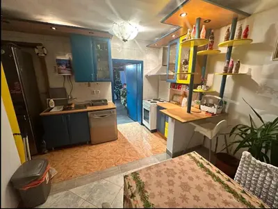 a kitchen with blue cabinets and a counter top at Huge Apartment 100sqm in Belgrade