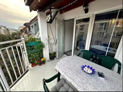 a table with a purple flower on a balcony at Huge Apartment 100sqm in Belgrade