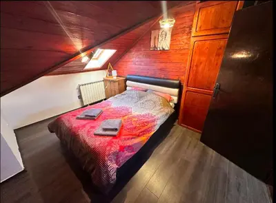 a bedroom with a bed in a wooden room at Huge Apartment 100sqm in Belgrade