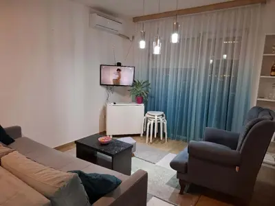 a living room with a couch and a tv at Stan na dan Ub in Ub