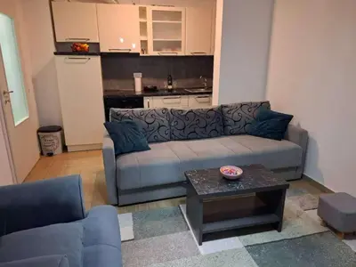 a living room with a couch and a table at Stan na dan Ub in Ub