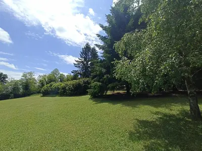 a large green field with trees and a blue sky at Ranch V8 Kosmaj in Rogača