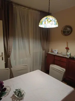 a dining room with a table and a light at Dunav centar 7 in Smederevo