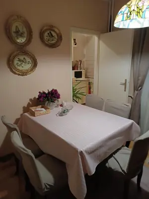 a table with a white table cloth and flowers on it at Dunav centar 7 in Smederevo