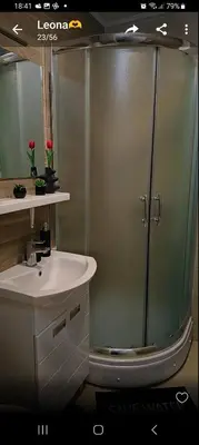 a bathroom with a glass shower and a sink at Apartment Leona in Inđija