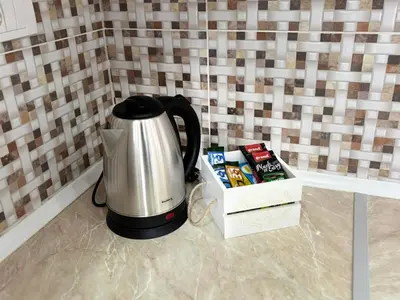 a coffee pot sitting next to a box of books at Apartment Leona in Inđija