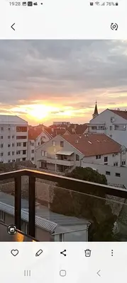 a view of a city at sunset from a balcony at Apartment Leona in Inđija