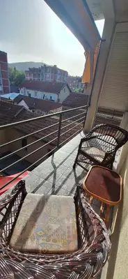 two wicker chairs sitting on a balcony at Divna in Arandjelovac