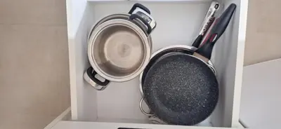 two pots and a pan in a white drawer at Divna in Arandjelovac