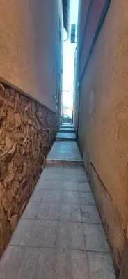 an empty hallway with a stone wall and a sidewalk at Divna in Arandjelovac