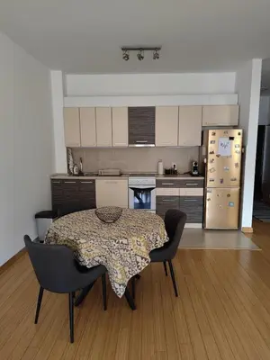 a kitchen with a table and chairs and a refrigerator at City center Dorcol free parking in Belgrade