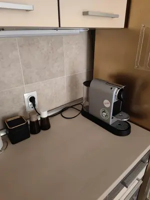 a kitchen counter with a coffeemaker on a counter top at City center Dorcol free parking in Belgrade