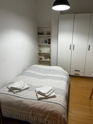 a bedroom with a bed with towels on it at City center Dorcol free parking in Belgrade