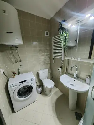 a bathroom with a washing machine and a sink at City center Dorcol free parking in Belgrade