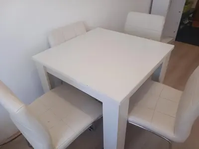a white table and two white chairs in a room at Djordje in Belgrade