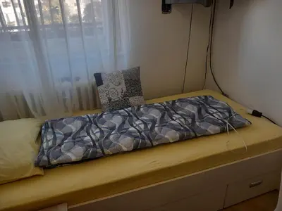 a small bed in a room with a window at Djordje in Belgrade