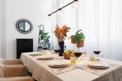 a dining room table with glasses of wine at Creative Shelter 108m2 with Balcony Old Town in Belgrade