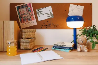 a desk with a lamp and books on it at Creative Shelter 108m2 with Balcony Old Town in Belgrade