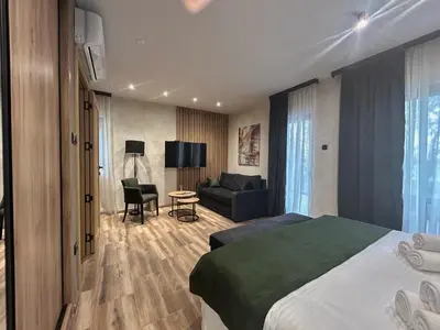 a hotel room with a bed and a couch at Belvedere RESORT in Smederevo