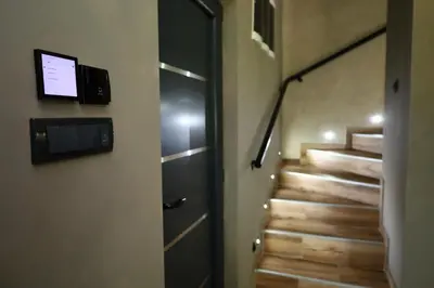 a hallway with stairs with a door and a television at Belvedere RESORT in Smederevo