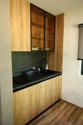 a kitchen with a sink and a black counter top at Belvedere RESORT in Smederevo