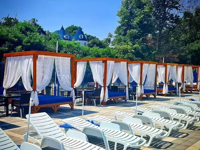 a row of chairs and tables and white chairs at Belvedere RESORT in Smederevo