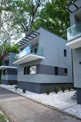 a gray house with a window on the side of it at Belvedere RESORT in Smederevo