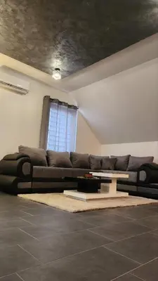 a living room with a couch and a table at Crassula Lux 2 in Surčin