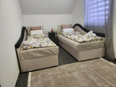 two beds sitting next to each other in a room at Crassula Lux 2 in Surčin