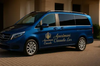 a blue van parked in front of a building at Crassula Lux 2 in Surčin