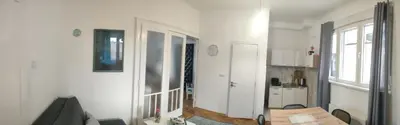a living room with white walls and a table at Vuk 1 in Belgrade