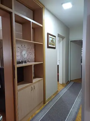 a hallway with a room with a wooden door at Beautiful house in Smederevo